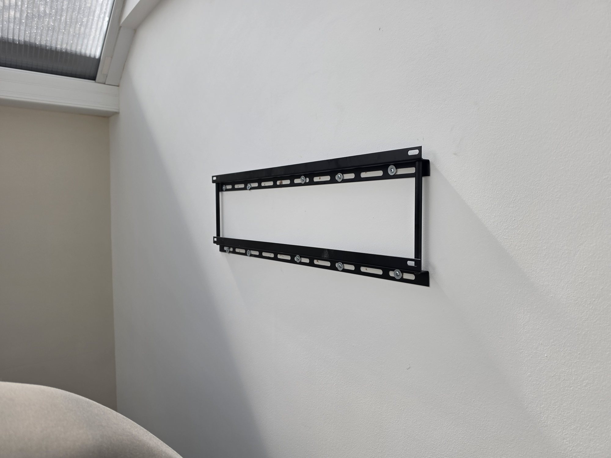 TV wall bracket being positioned during an Evolution Data and Digital installation