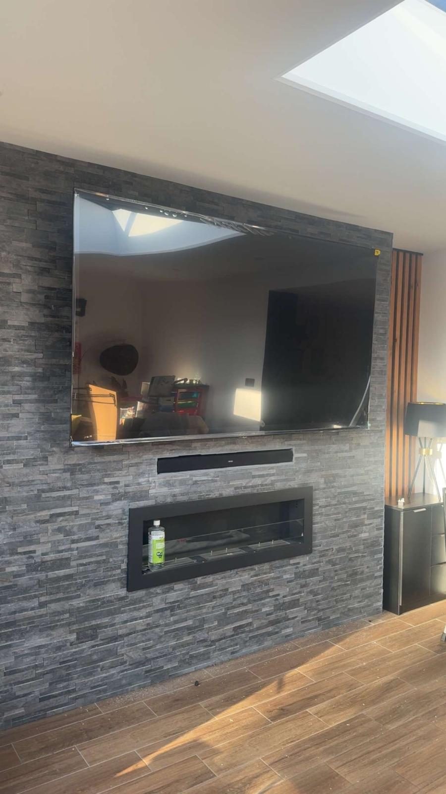 Media wall TV installation with stone finish and hidden cables — Stockport