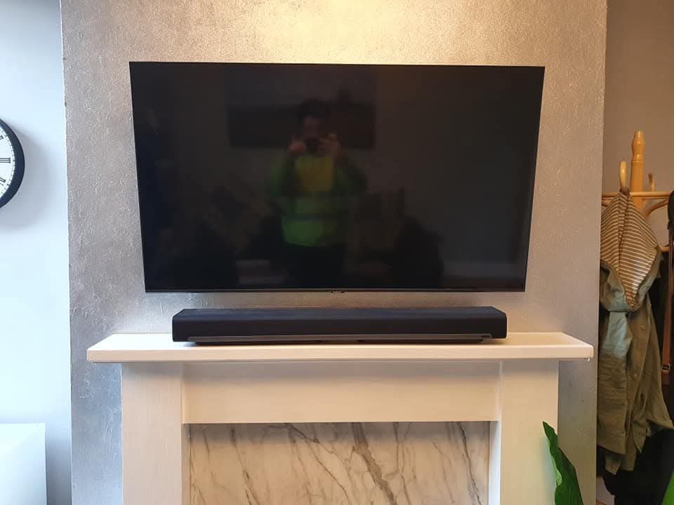 TV wall mount installation with neat cable management in Stockport