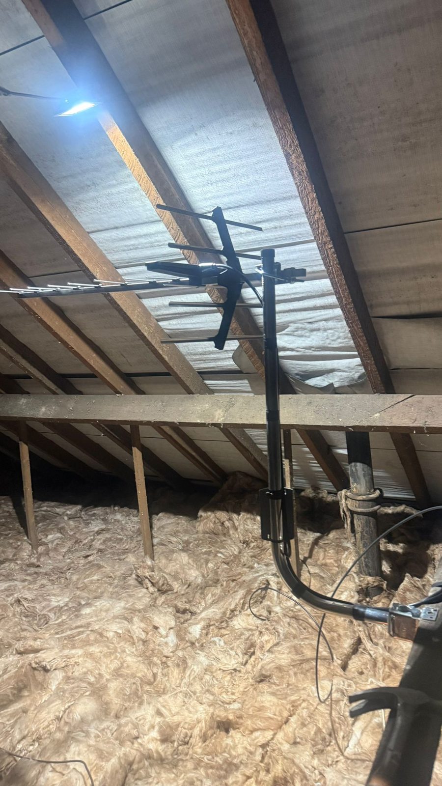 Loft-mounted TV aerial fixed to a rafter inside a Stockport roof space