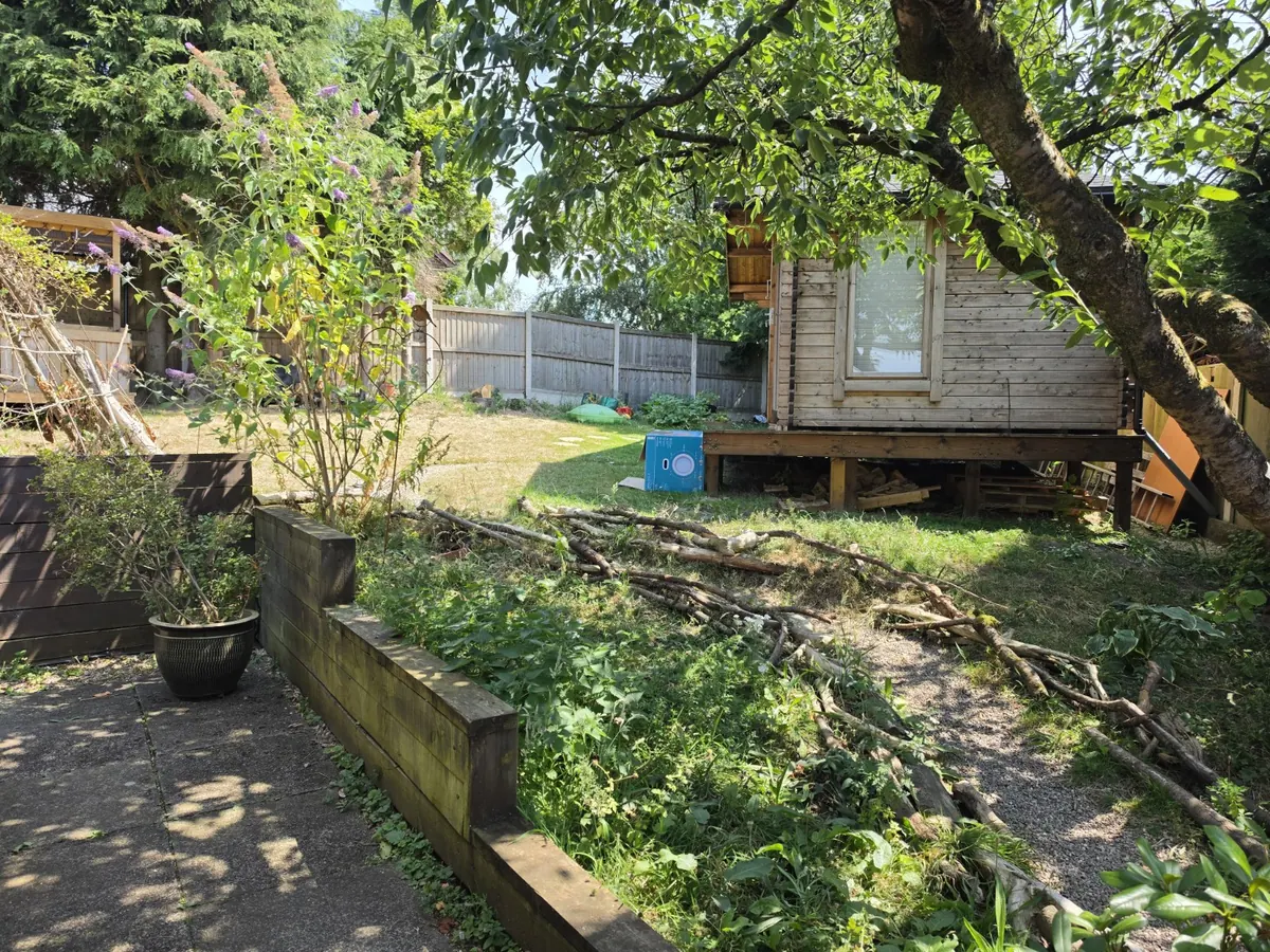 Detached timber garden office in a Glossop garden connected by an external data cable route