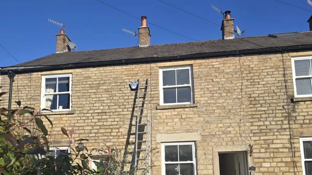 Engineer fitting an additional TV point in a Stockport home