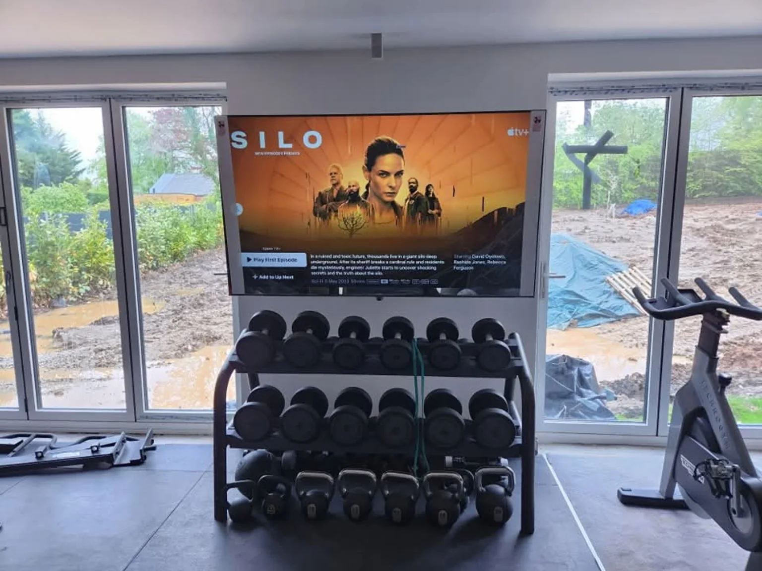 Closer view of the home gym TV wall mount above a dumbbell rack in Bamber Bridge