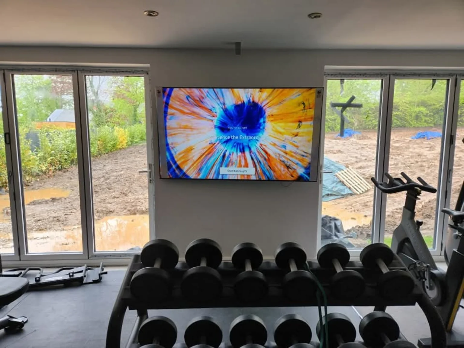 Wall-mounted TV between glazed doors in a home gym in Bamber Bridge, Preston